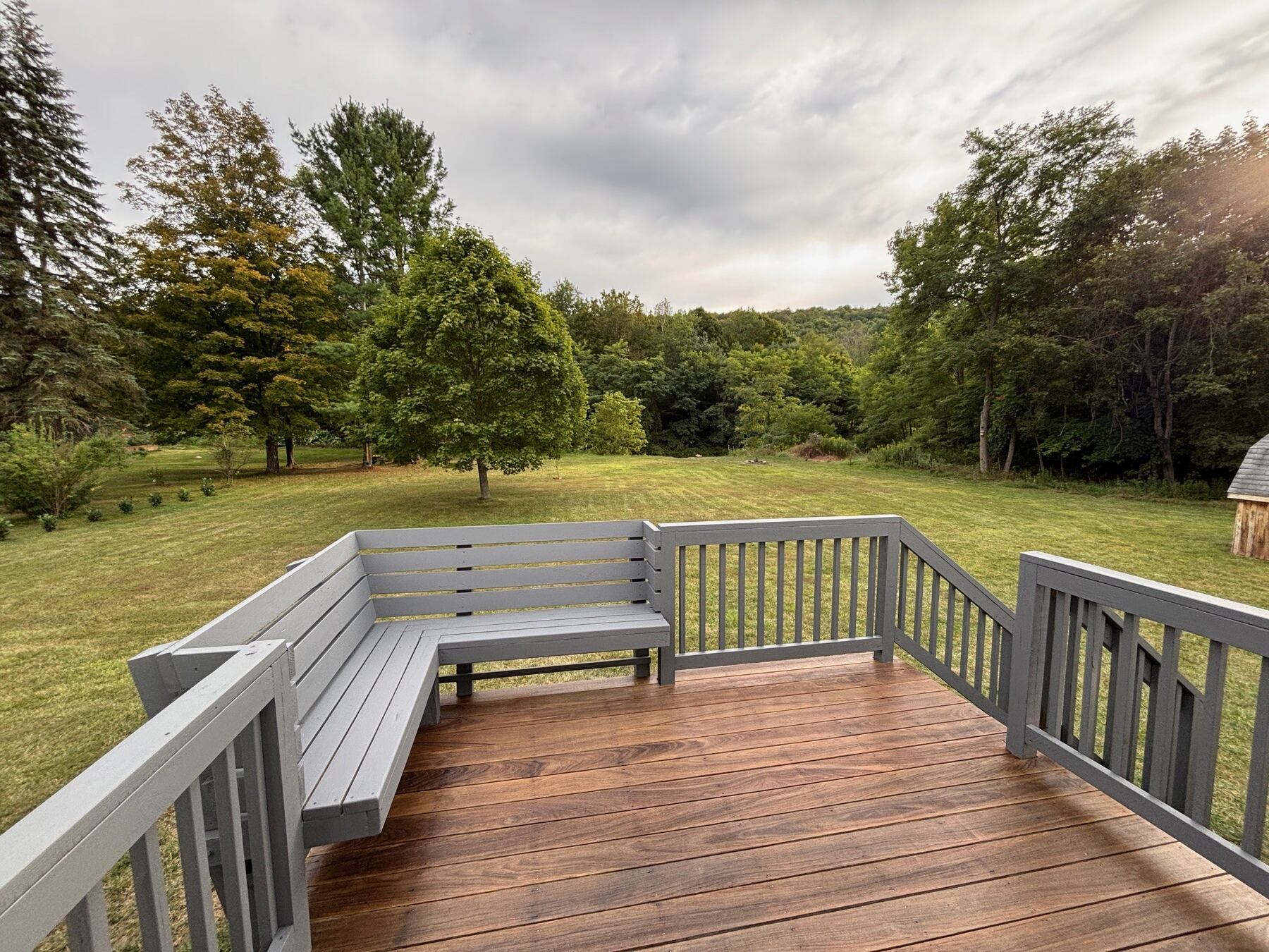 Deck overlooking the wooded backyard at Whispering River